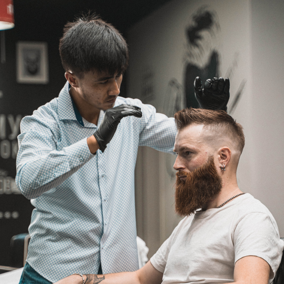 Barber i gang med at style en moderne herrefrisure. Find din hårtype i vores guide